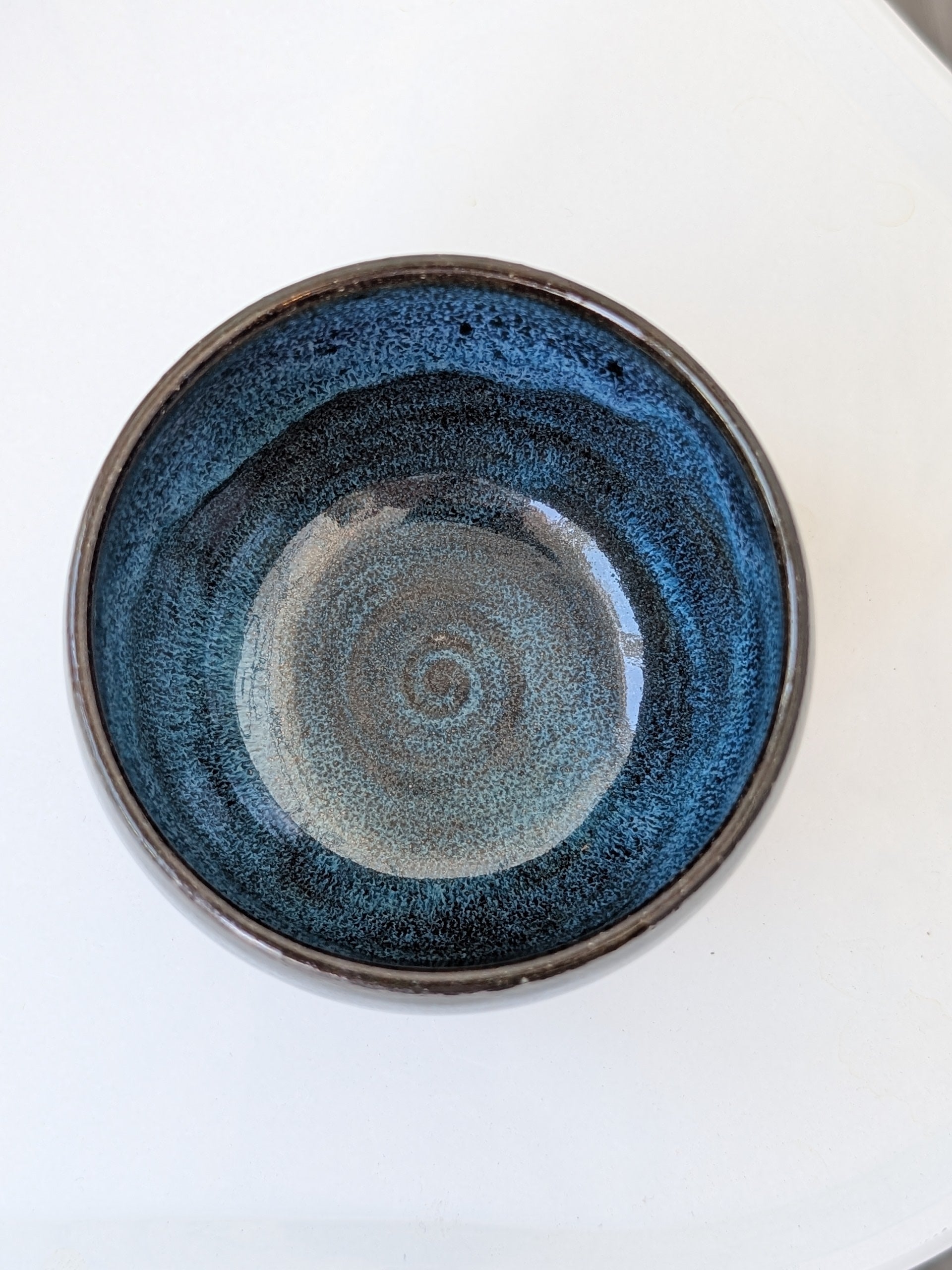 Blue ceramic plate with a textured surface on a white background