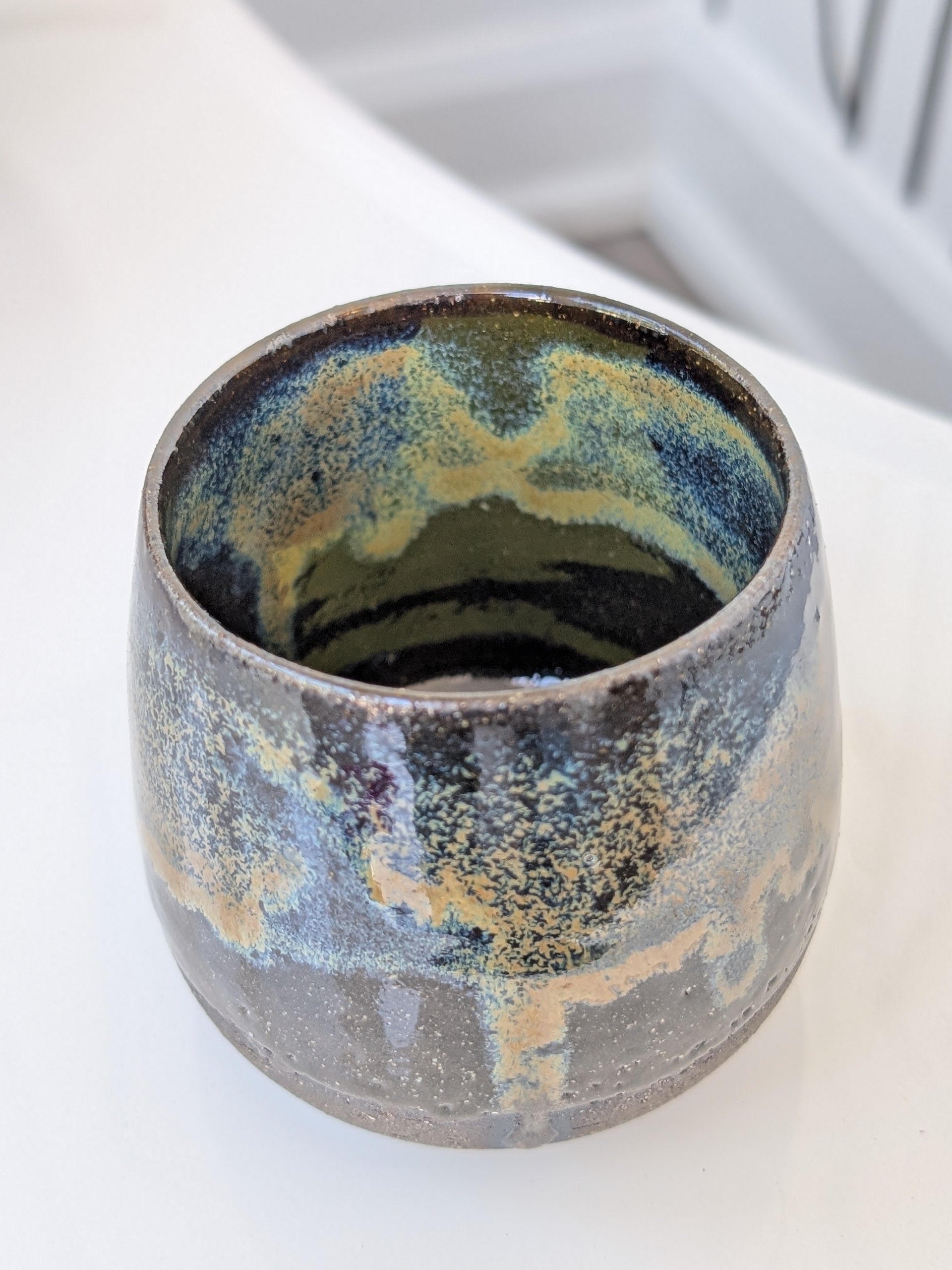 Ceramic cup with textured surface on a white background