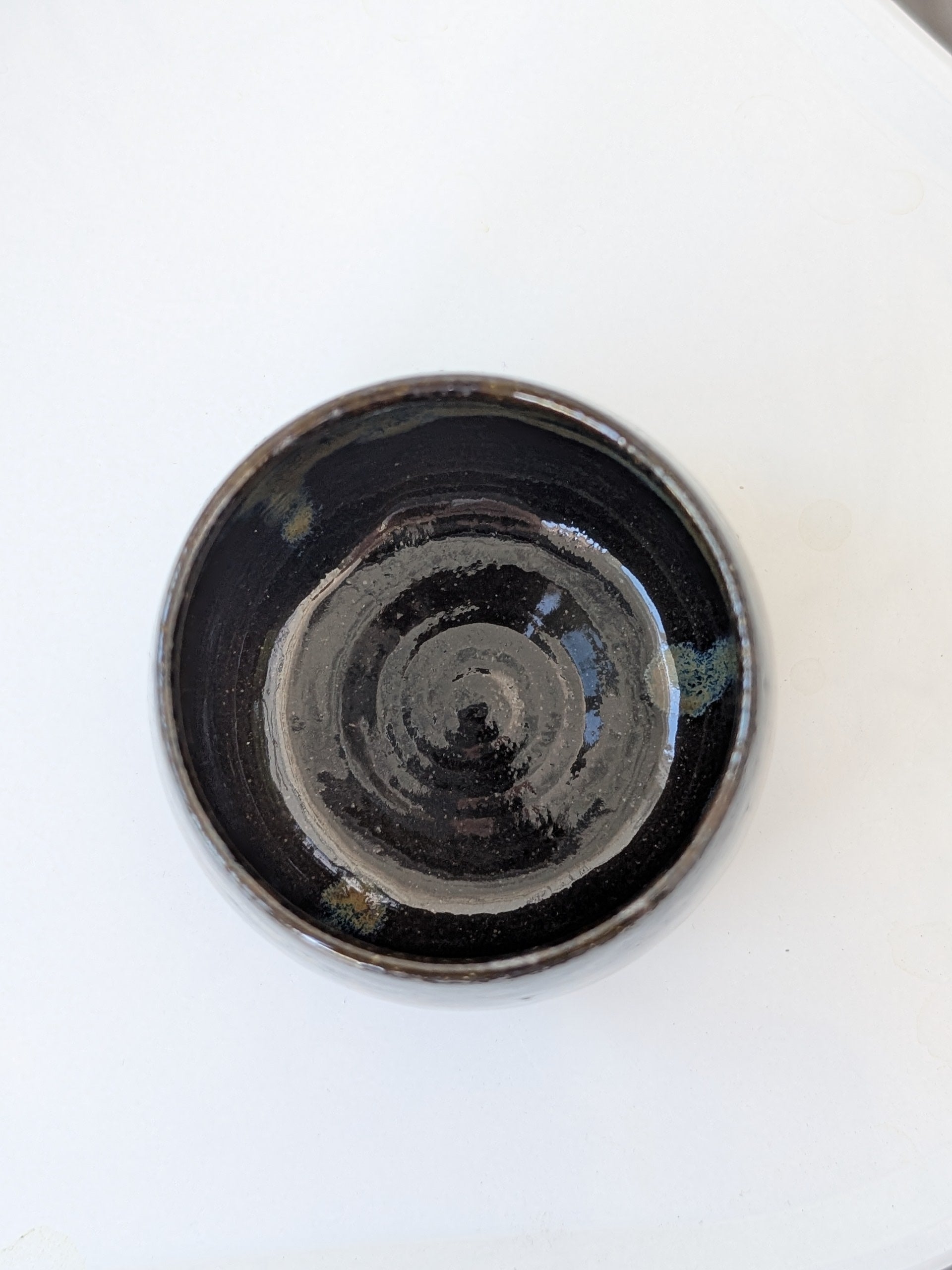 Black ceramic cup on a white background