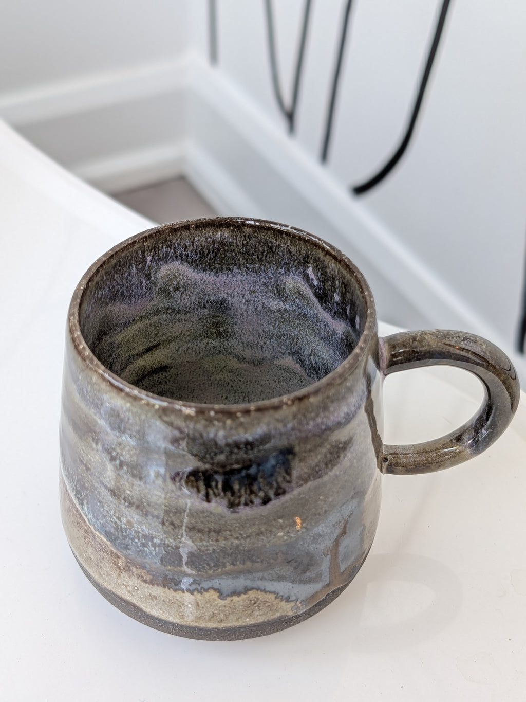 Ceramic mug with a textured surface on a white countertop