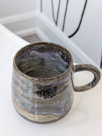 Ceramic mug with a textured surface on a white countertop