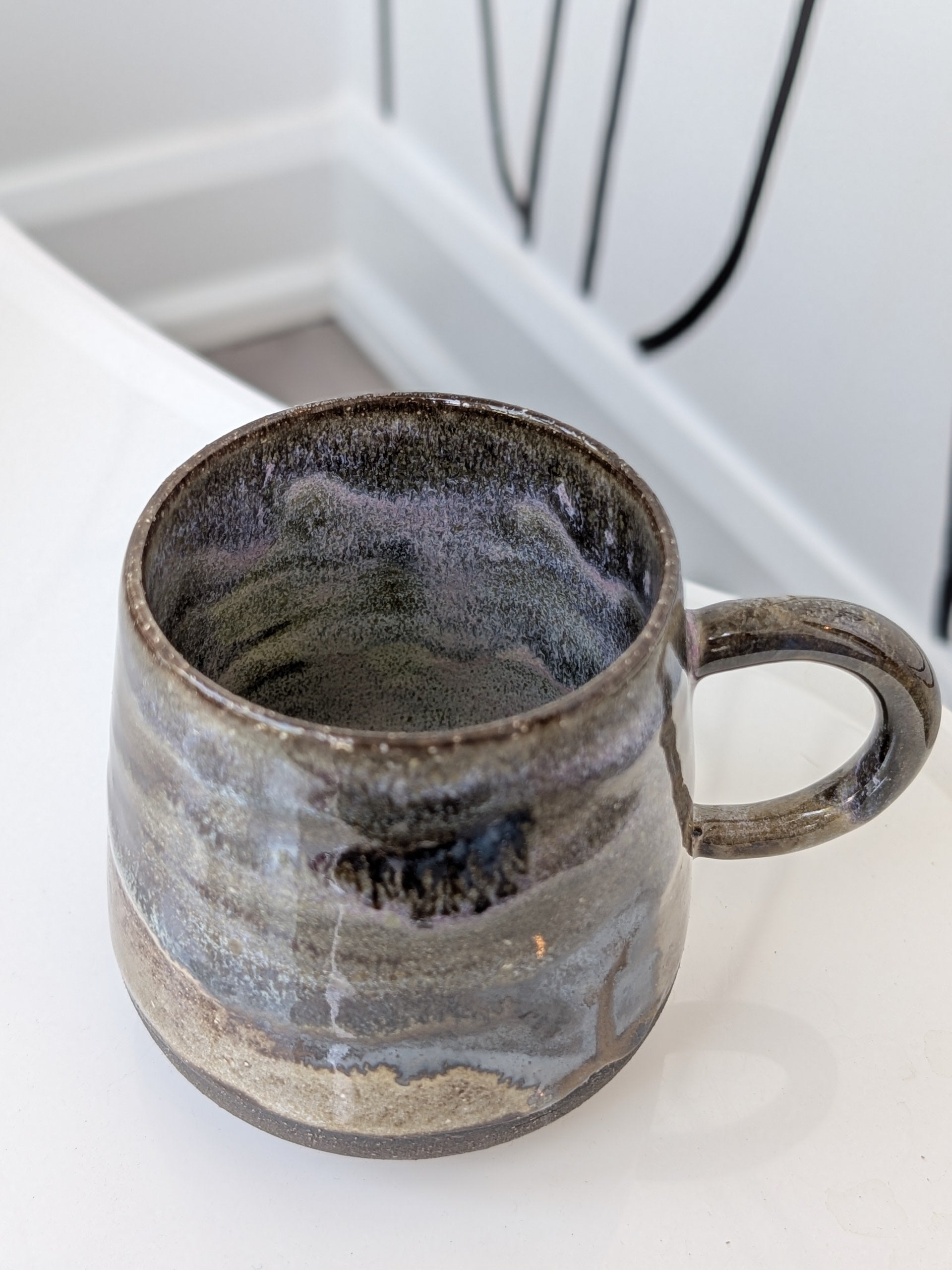 Ceramic mug with a textured surface on a white countertop