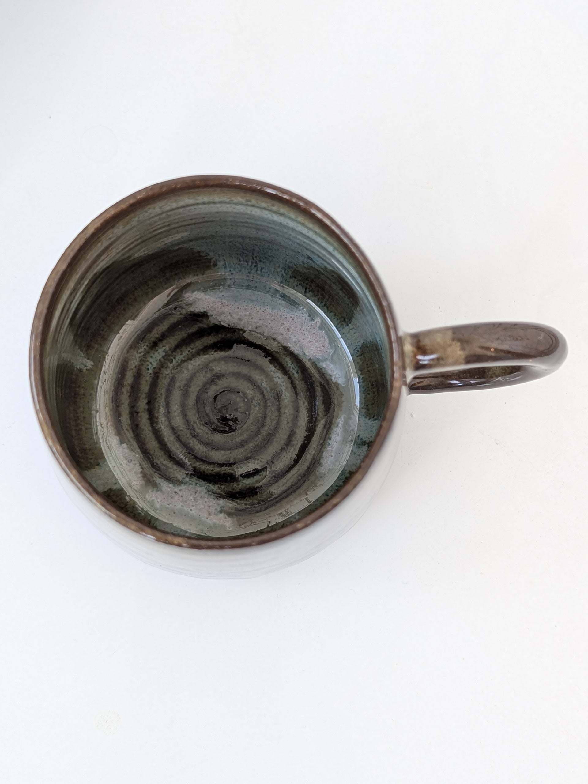 Ceramic mug with spiral pattern on a white background
