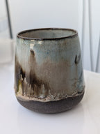Ceramic mug with artistic design on a white surface