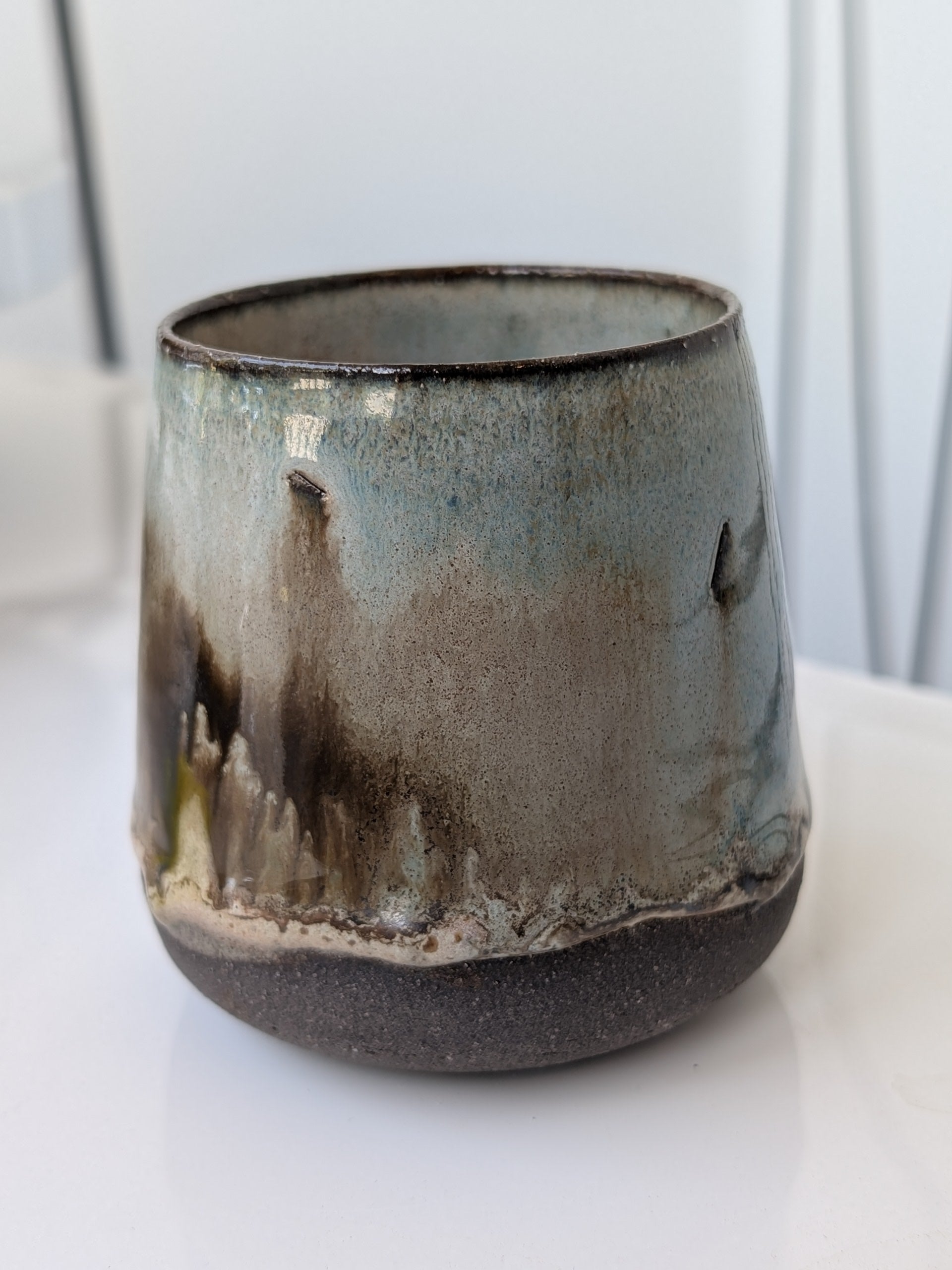 Ceramic mug with artistic design on a white surface
