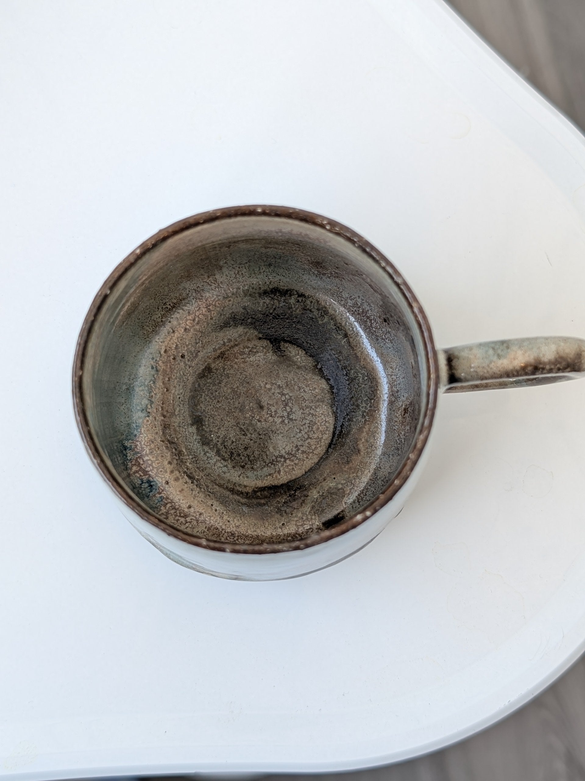 Ceramic mug on white surface