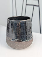 Handmade black glazed ceramic cup, front view