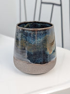 Handmade blue and brown glazed ceramic cup, front view