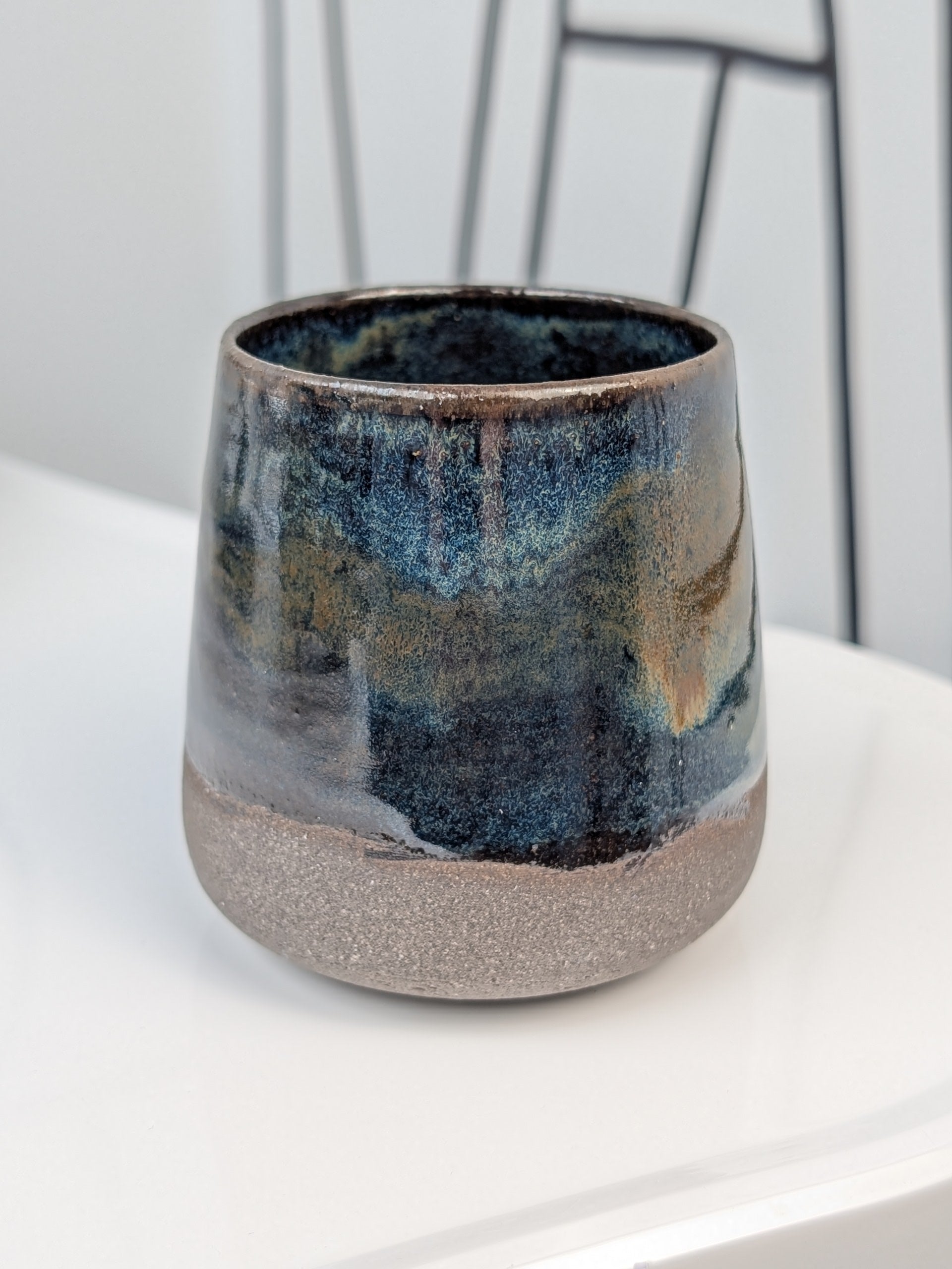 Handmade blue and brown glazed ceramic cup, front view
