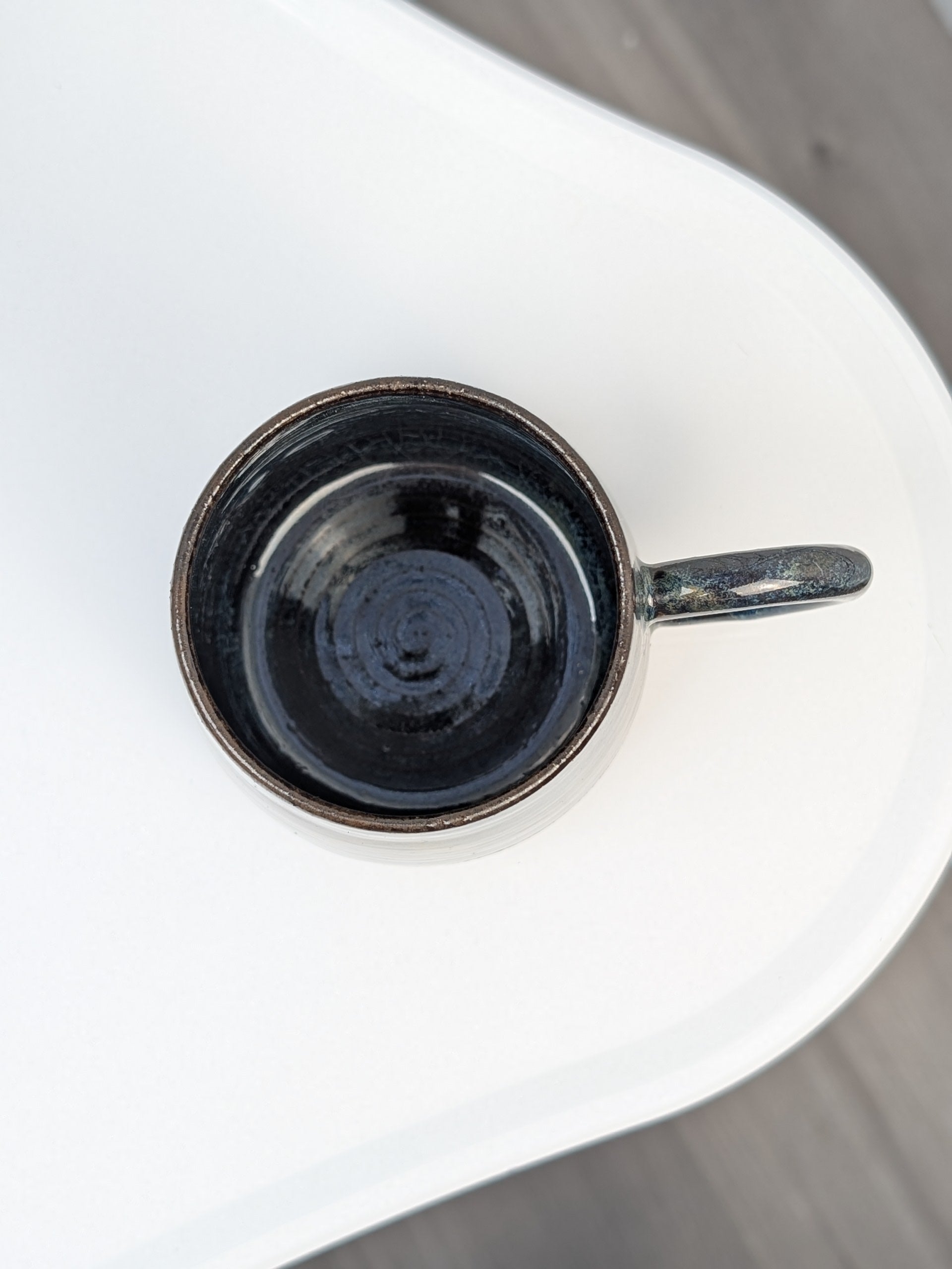 Handmade blue and brown glazed ceramic cup, top view