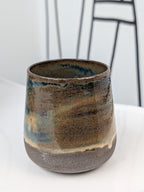 Handmade blue and brown glazed ceramic cup, front view