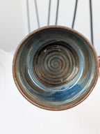 Handmade blue and brown glazed ceramic cup, top view