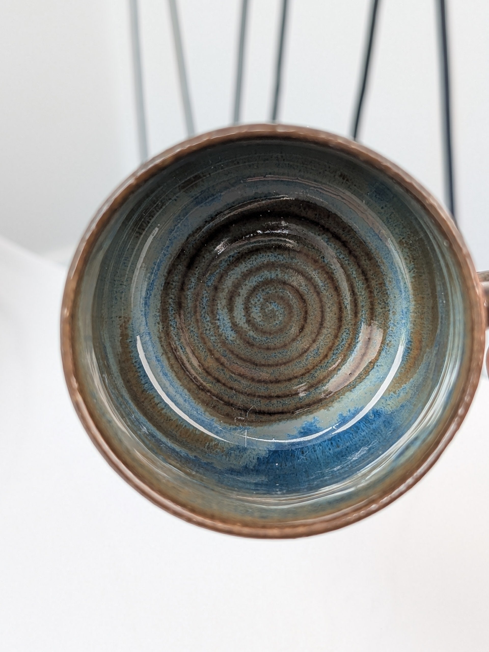 Handmade blue and brown glazed ceramic cup, top view
